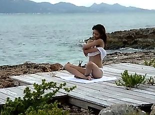 Chinese angel teasing by the ocean